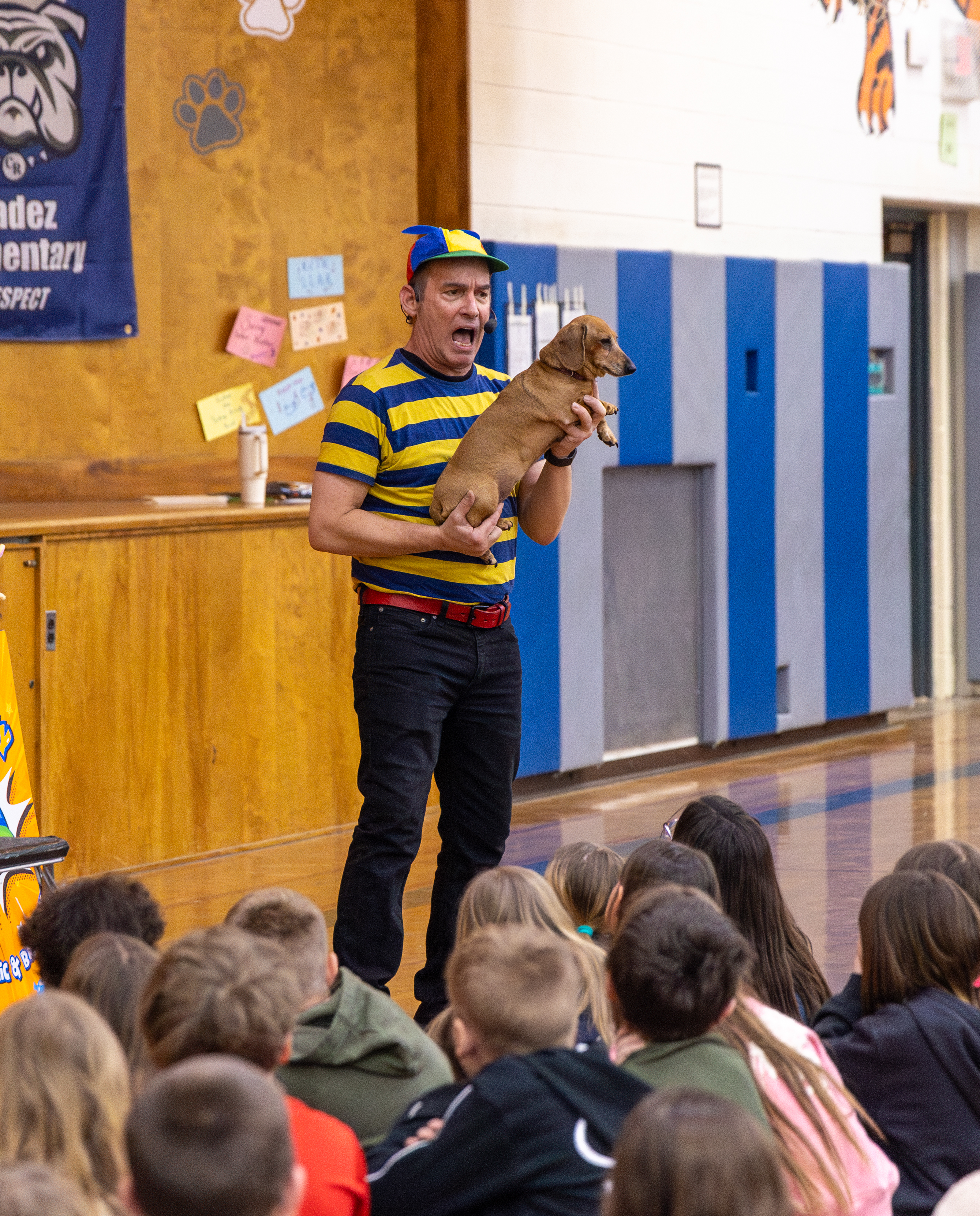 Mr. Twisty lifting Penny up for the audience