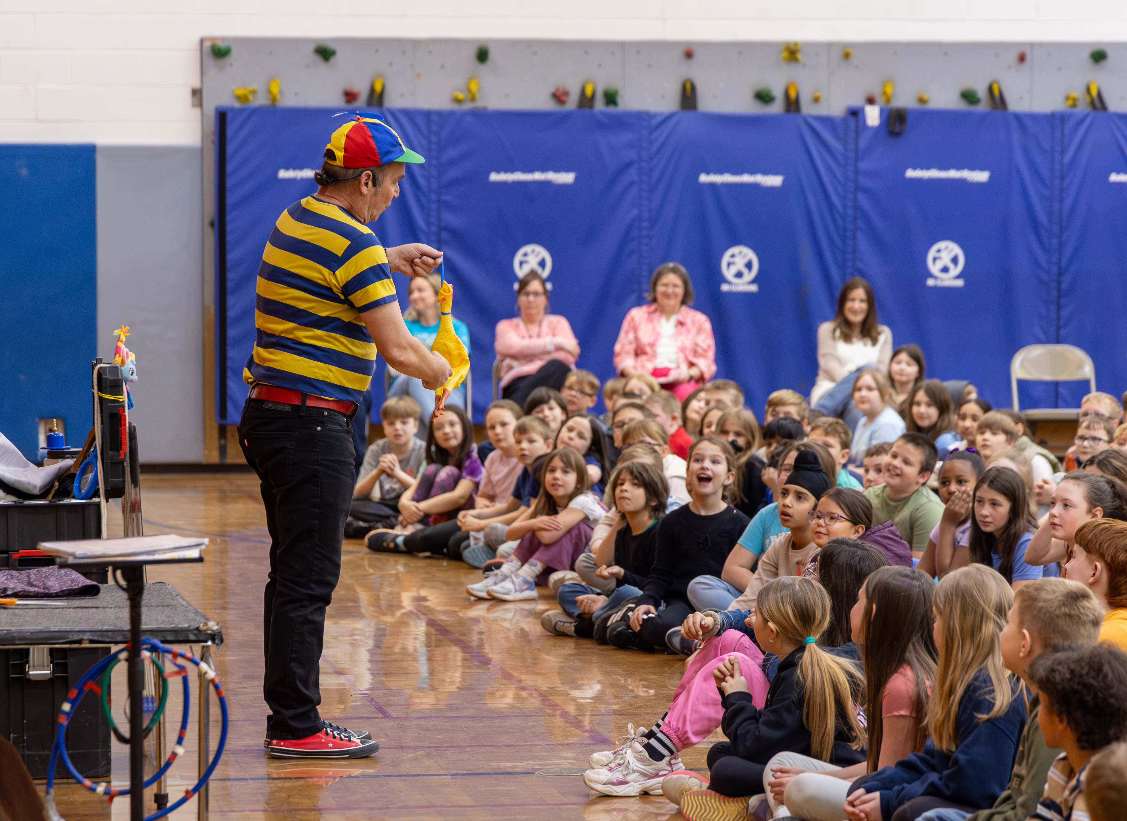 Mr. Twisty performing with teachers and students watching